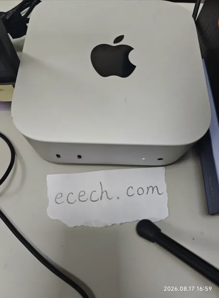 The Mac mini the ecech. site is built on, beside a handwritten note reading ecech.com.