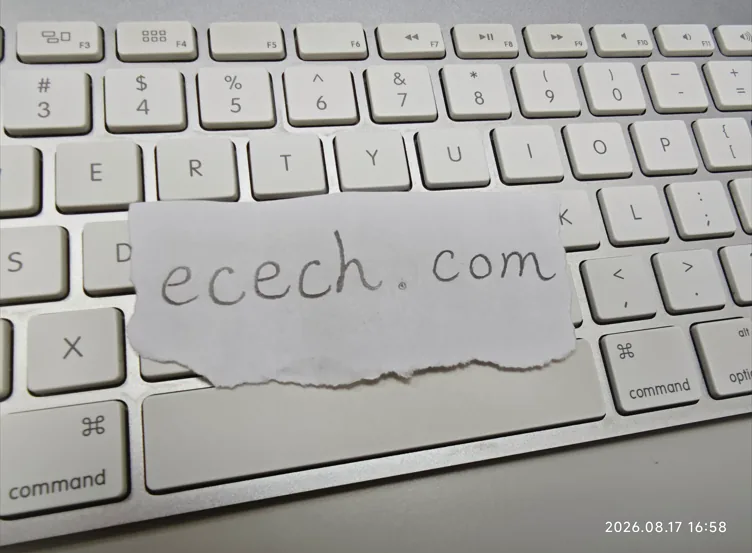The desk where ecech. tools get written: a laptop, a notebook of to-dos and a whiteboard listing the tools on the site.